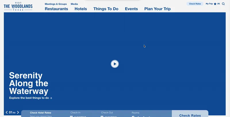 The Visit The Woodlands homepage: a full-width blue video banner reading “Serenity along the waterway,” with a hotel search bar below.